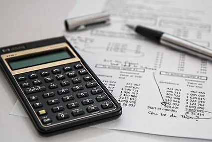 Calculator and planning papers representing practical financial literacy
